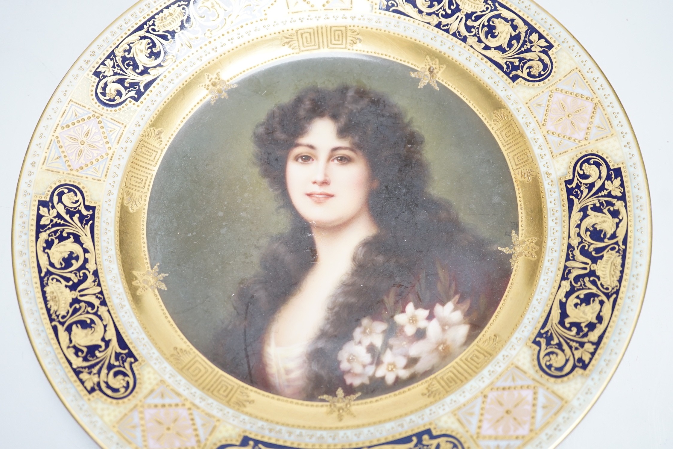 A Vienna cabinet plate with portrait painting to centre, underglaze blue beehive mark to reverse. 24cm diameter